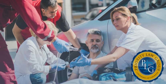 Man receiving medical aid near car